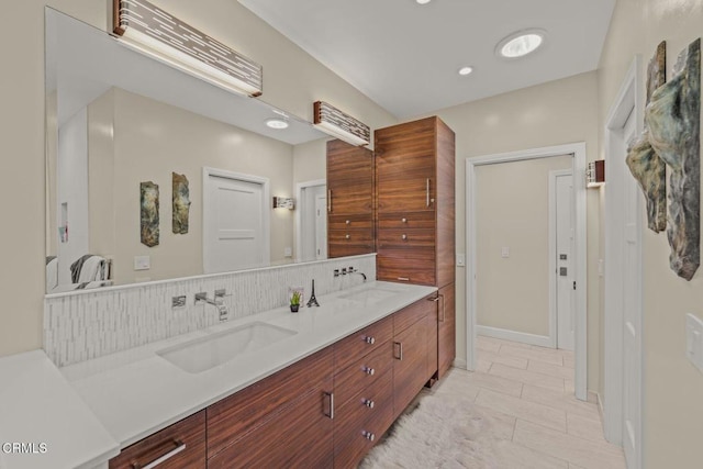 bathroom with double vanity, decorative backsplash, recessed lighting, and a sink