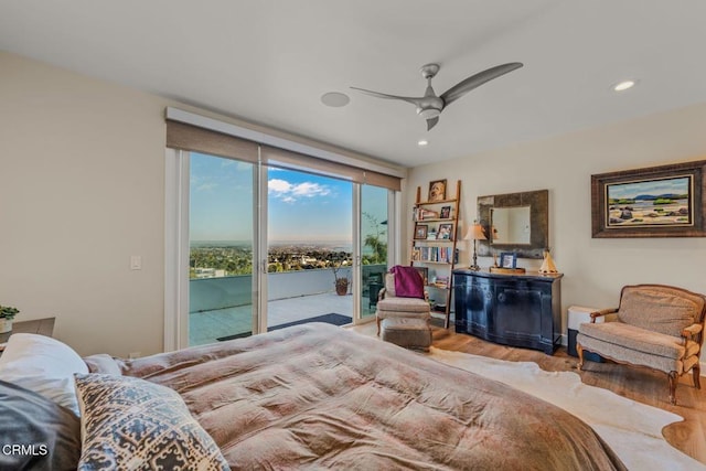 bedroom with expansive windows, access to exterior, a ceiling fan, wood finished floors, and recessed lighting