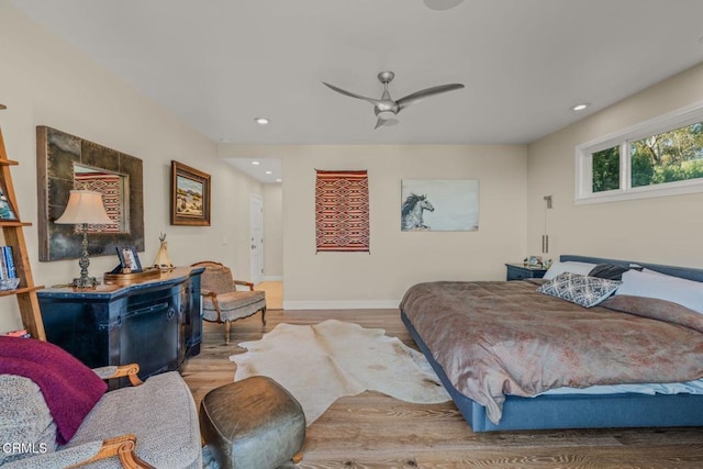 bedroom featuring a ceiling fan, recessed lighting, baseboards, and wood finished floors
