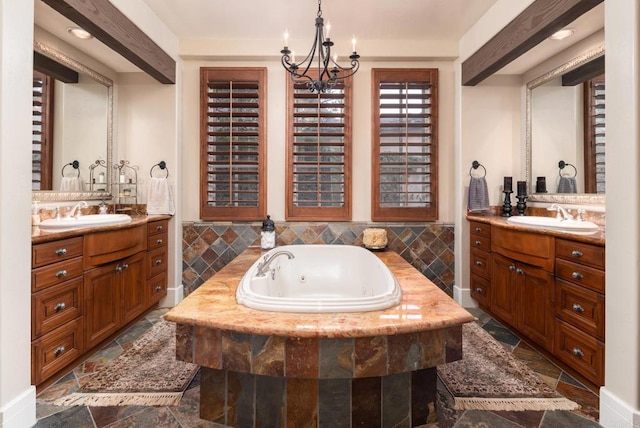 full bathroom featuring a sink, two vanities, and stone tile flooring