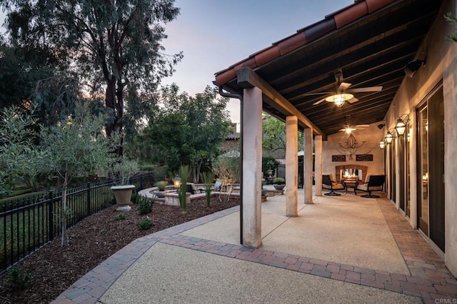 view of patio featuring a ceiling fan and fence