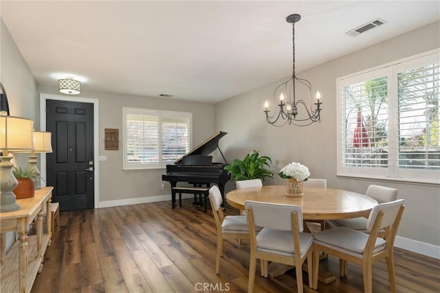 dining space with dark wood-type flooring, baseboards, and visible vents