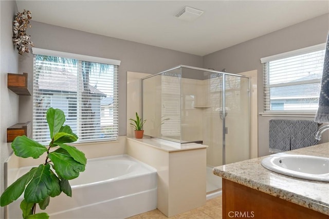 full bathroom featuring visible vents, a healthy amount of sunlight, a bath, and a shower stall