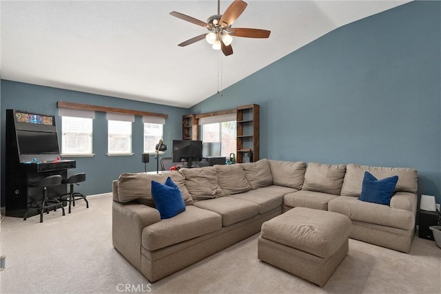 living area with baseboards, carpet, ceiling fan, and vaulted ceiling