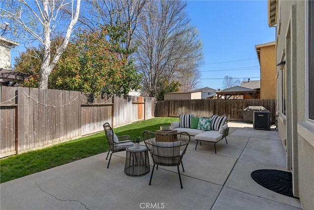 view of patio featuring an outdoor living space and a fenced backyard