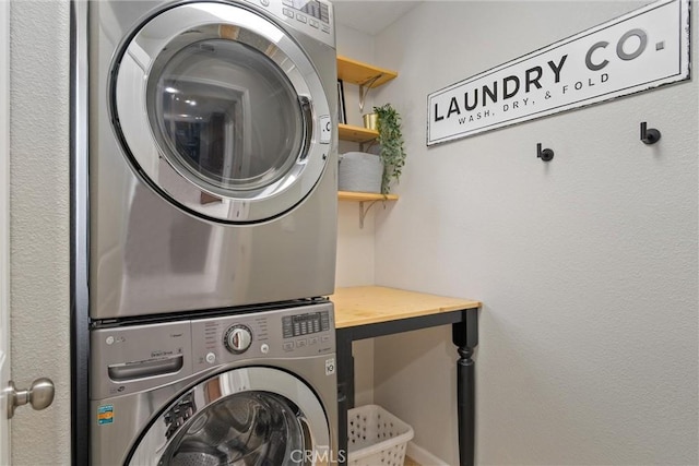 laundry area with laundry area and stacked washer / dryer