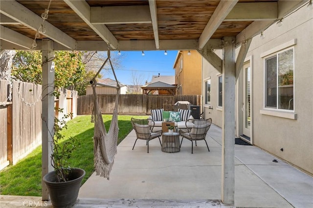 view of patio featuring outdoor lounge area and a fenced backyard