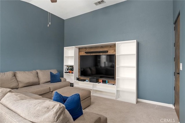 carpeted living room with visible vents, baseboards, and ceiling fan