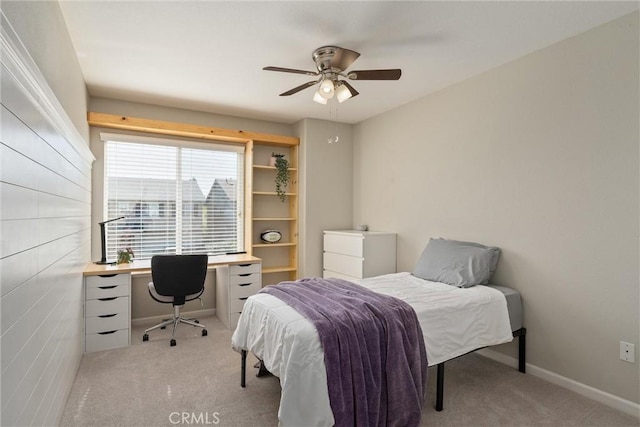 bedroom featuring a ceiling fan, baseboards, and light carpet