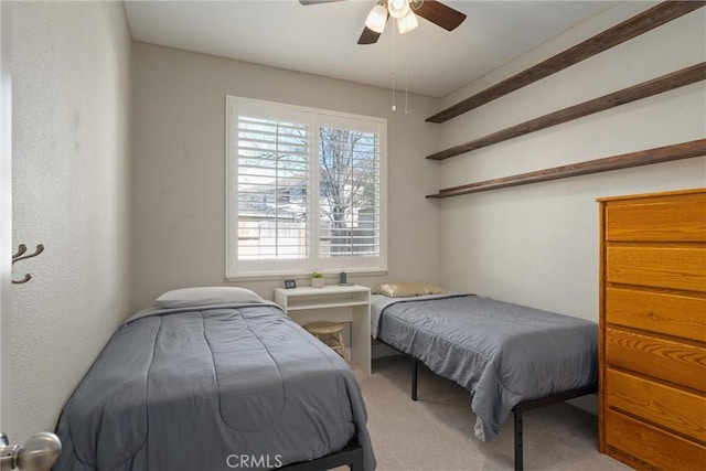 carpeted bedroom with a ceiling fan