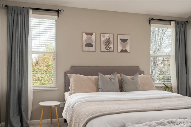 carpeted bedroom featuring baseboards