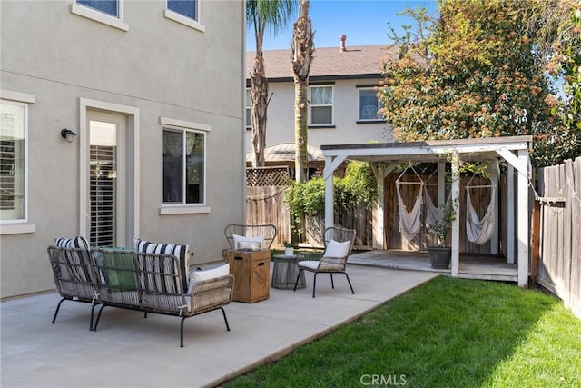 view of patio / terrace featuring outdoor lounge area and fence