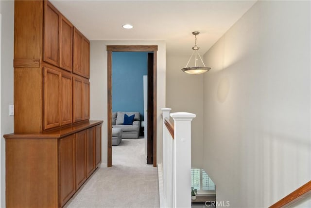 corridor with an upstairs landing, recessed lighting, light colored carpet, and baseboards