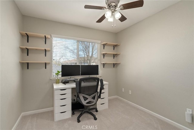 home office featuring baseboards, light colored carpet, and a ceiling fan