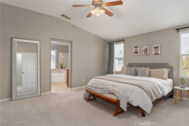 bedroom with visible vents, multiple windows, light colored carpet, and vaulted ceiling