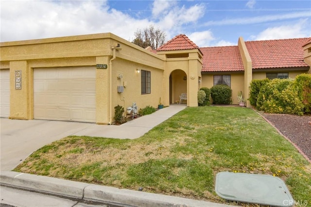 view of front of house with a front yard, stucco siding, concrete driveway, a garage, and a tile roof