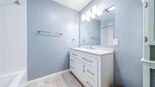 full bath with vanity, shower / bathing tub combination, baseboards, and wood finished floors