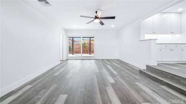 unfurnished living room with visible vents, a ceiling fan, recessed lighting, light wood finished floors, and baseboards