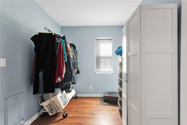 interior space with wood finished floors and baseboards