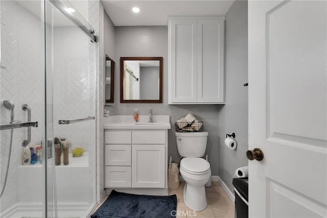 full bath featuring a shower stall, baseboards, toilet, tile patterned floors, and vanity