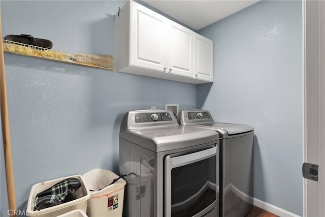 laundry room featuring cabinet space, independent washer and dryer, and baseboards