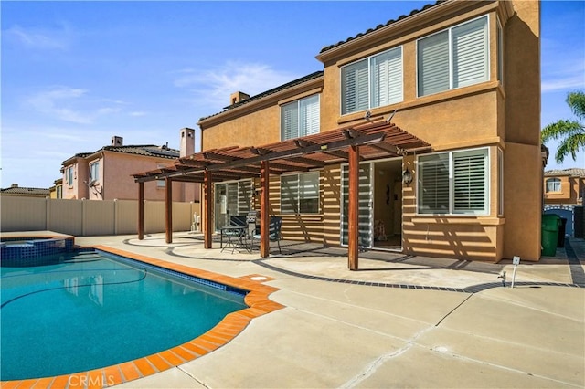 view of swimming pool with a pool with connected hot tub, a pergola, a patio, and fence