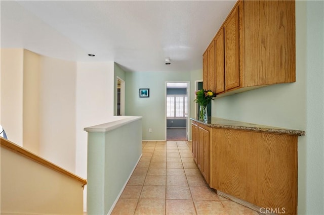 hall with light tile patterned floors and baseboards