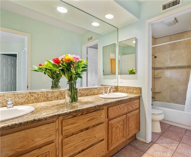 bathroom with visible vents, toilet, and a sink