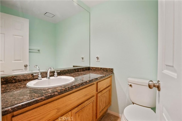 bathroom with tile patterned floors, toilet, and vanity