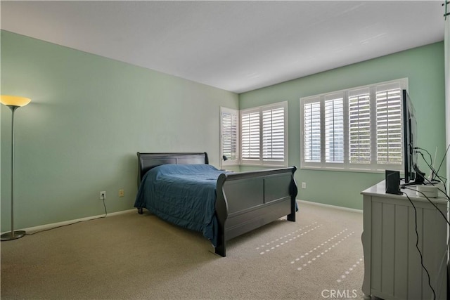 bedroom featuring baseboards and carpet floors