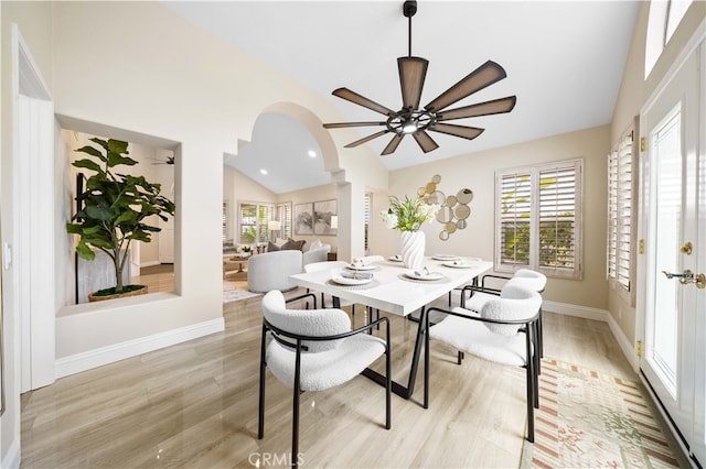 dining area with baseboards, light wood-style flooring, recessed lighting, arched walkways, and ceiling fan