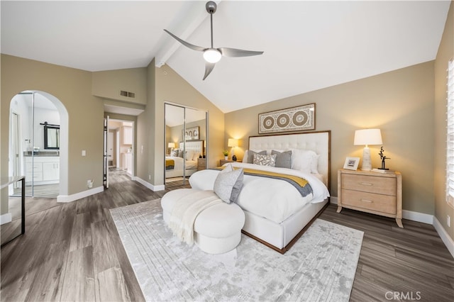 bedroom featuring beam ceiling, visible vents, dark wood finished floors, and arched walkways