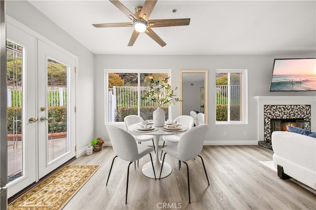 dining room with plenty of natural light, french doors, and light wood finished floors