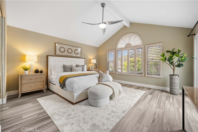 bedroom with light wood-type flooring, baseboards, ceiling fan, and vaulted ceiling with beams