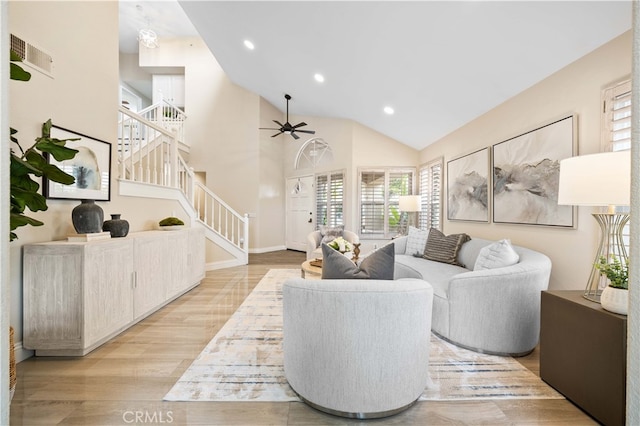 living room featuring ceiling fan, stairs, recessed lighting, light wood-style flooring, and high vaulted ceiling