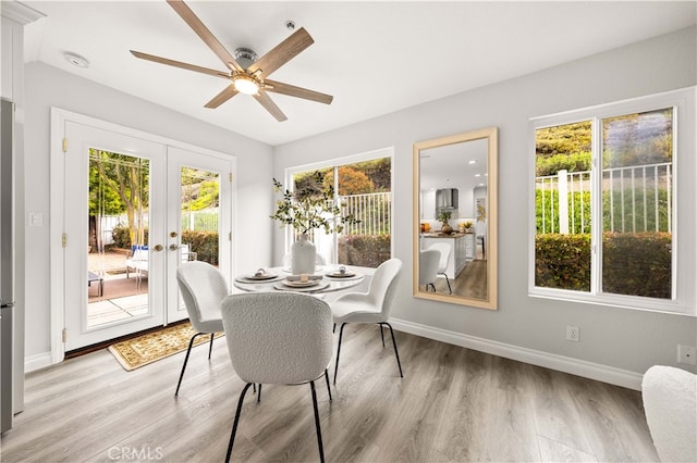 sunroom featuring french doors and a ceiling fan