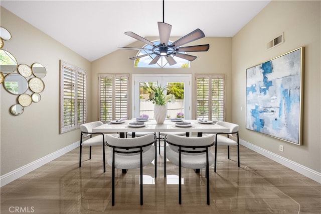 dining room featuring visible vents, baseboards, lofted ceiling, and ceiling fan