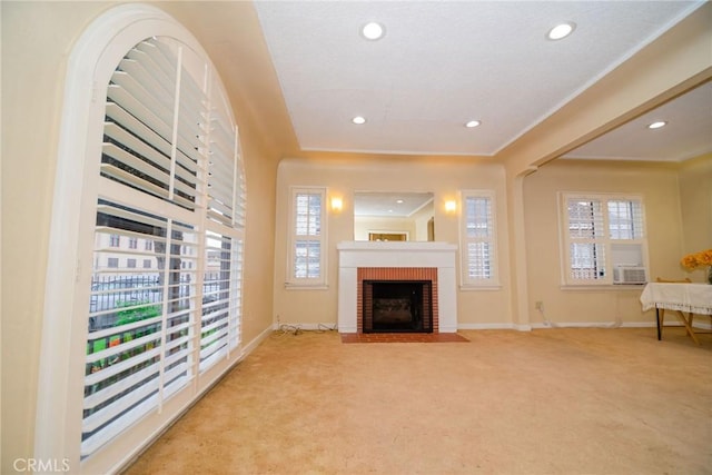 carpeted living area with recessed lighting, cooling unit, baseboards, and a fireplace