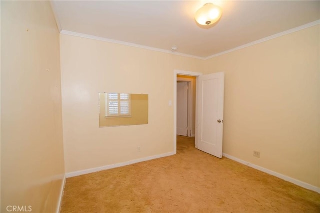 spare room featuring baseboards, carpet, and ornamental molding