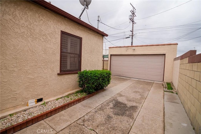 detached garage featuring fence