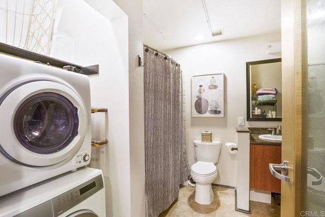 full bathroom with vanity, visible vents, tile patterned floors, stacked washer / dryer, and toilet