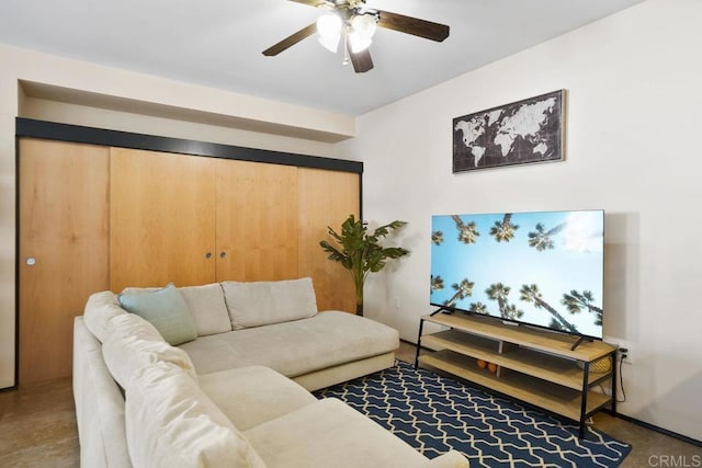 living area featuring a ceiling fan