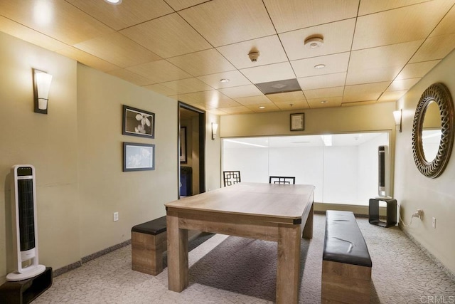 office space featuring a paneled ceiling, baseboards, and carpet flooring