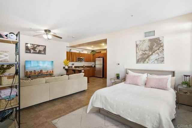 tiled bedroom with visible vents, freestanding refrigerator, and ceiling fan