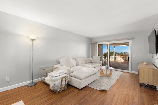 living room featuring wood finished floors and baseboards