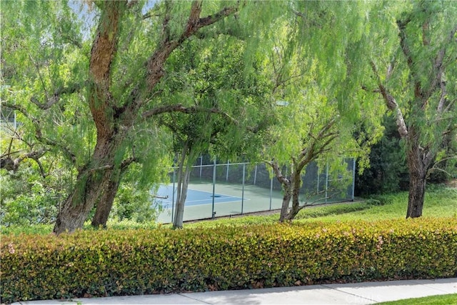 view of sport court featuring fence