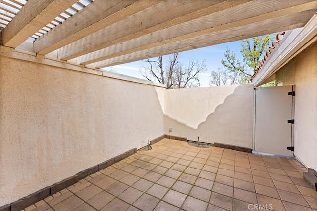 view of patio with a pergola and fence