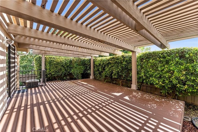 view of patio featuring a deck, fence, and a pergola