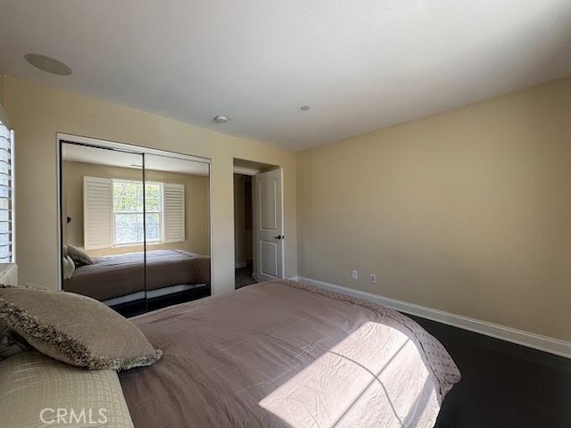 bedroom featuring a closet and baseboards