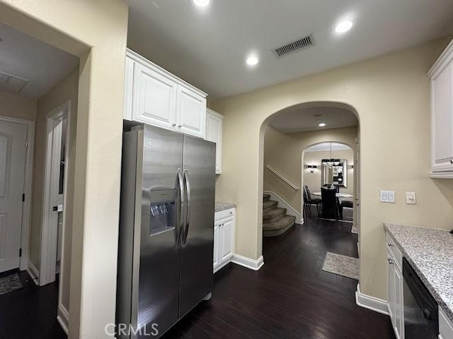 kitchen with visible vents, arched walkways, black dishwasher, stainless steel refrigerator with ice dispenser, and white cabinetry